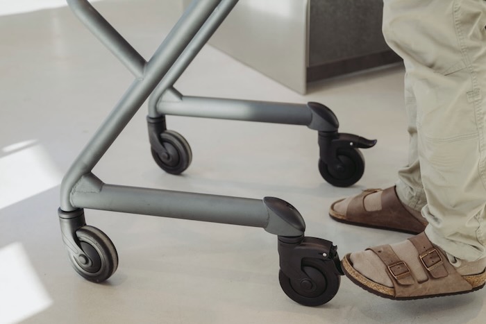 Indoor rollator with 4 wheels Man pushing Indoor rollator with 4 wheels