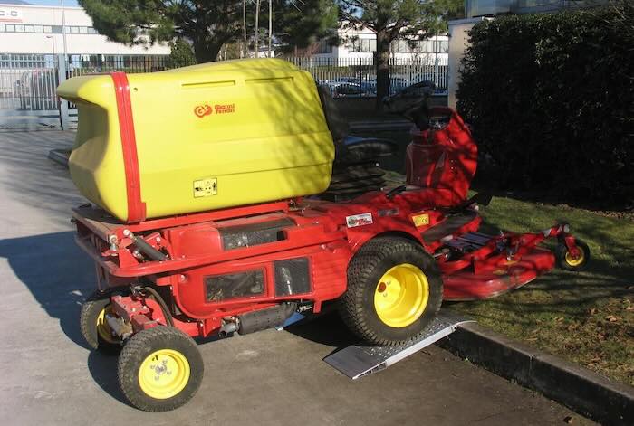 Machinery driving up pair of aluminium container ramps 