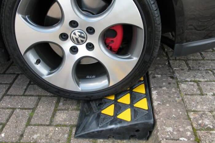 Kerb ramp with car driving up it 