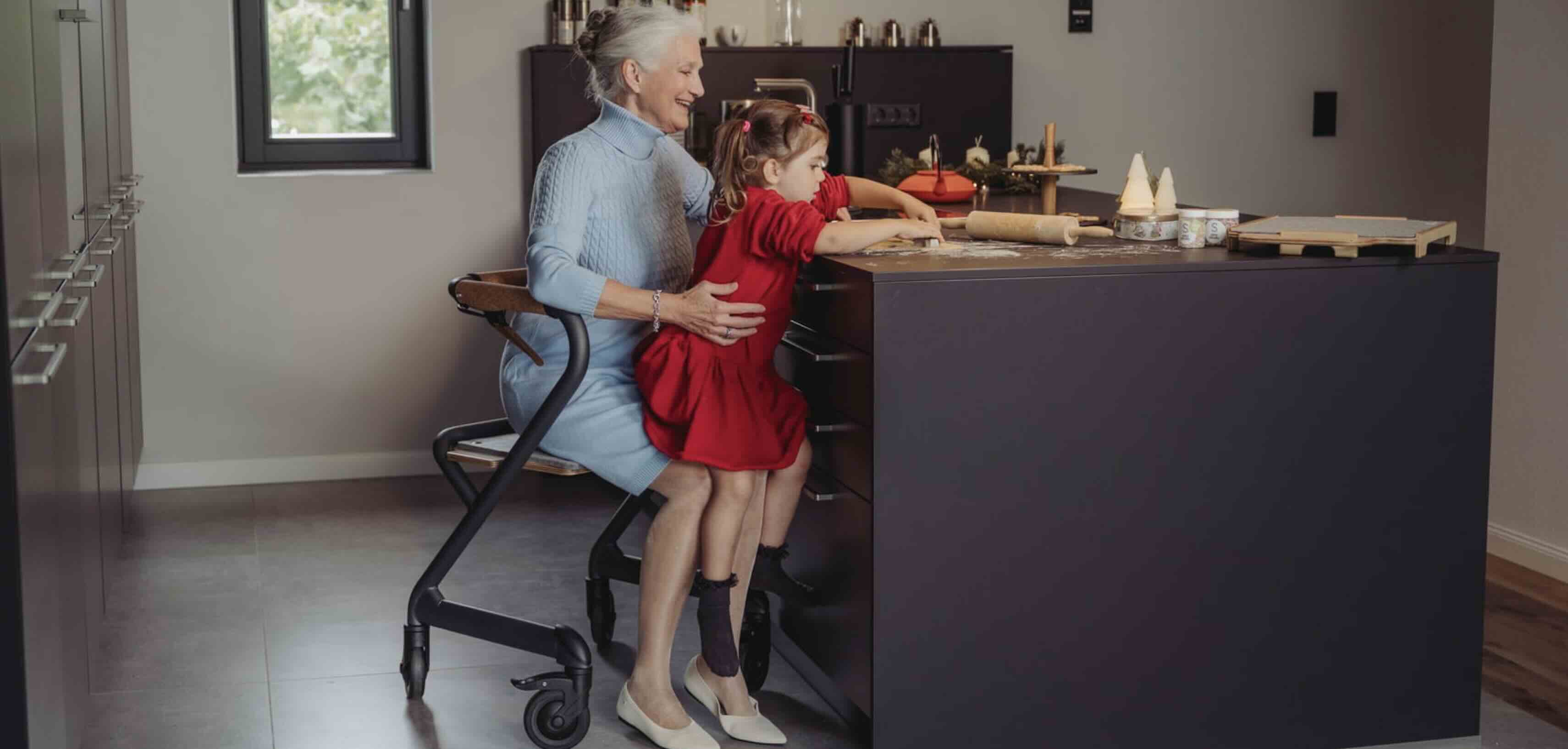 Indoor rollator in use in kitchen Lady using indoor rollator in kitchen making food