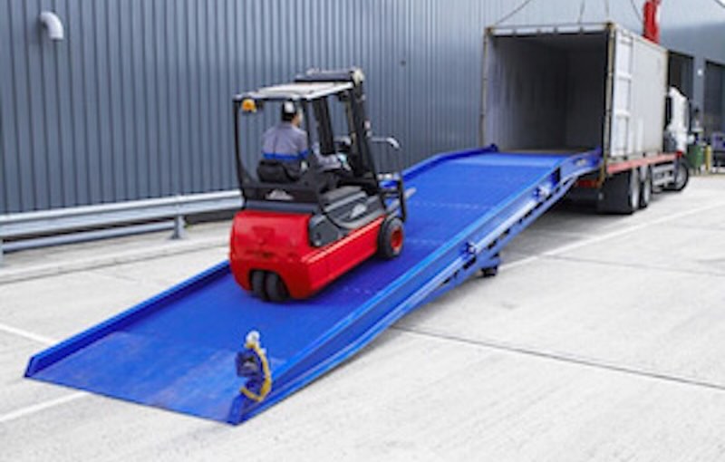 Forklift driving up steel yard ramp