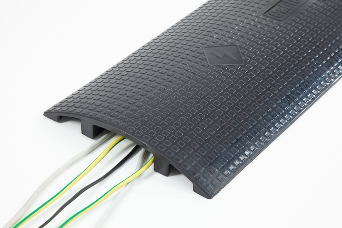 Floor cable protector with cable passing through 