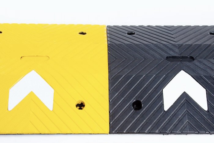 Black and yellow speed bump with reflective chevrons