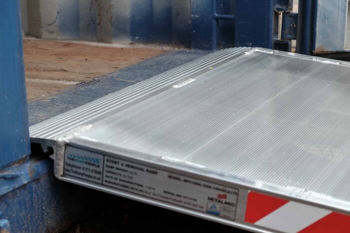 Pallet truck ramp resting on container Pallet truck ramp resting on container