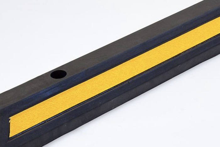 Black and yellow rubber wheel stops