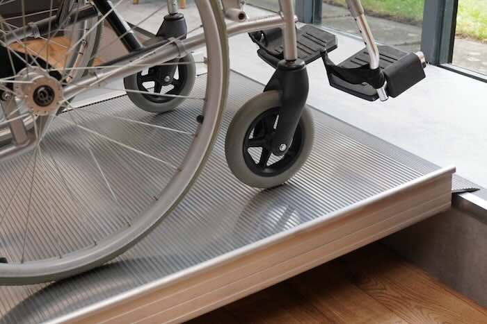 Wheelchair going up ramp