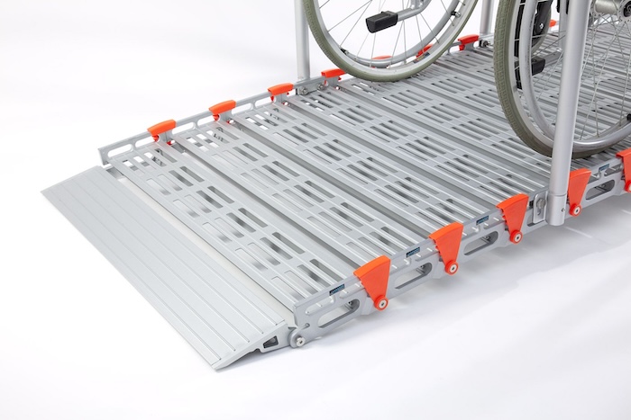 Wheelchair going up RollAble ramp 