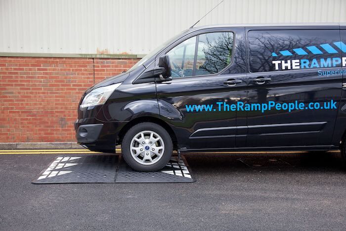 Black and white speed cushion with van driving over