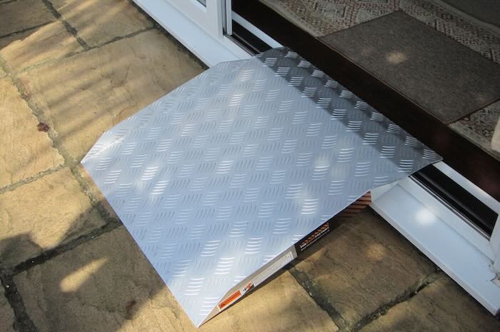 Aluminium wheelchair ramp on uPVC doorway 