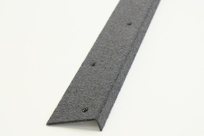 Black and yellow stair tread with anti-slip surface