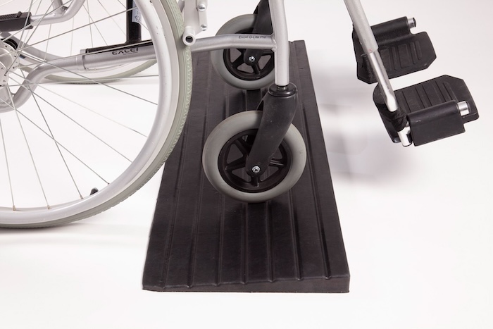 Wheelchair on rubber threshold ramp 