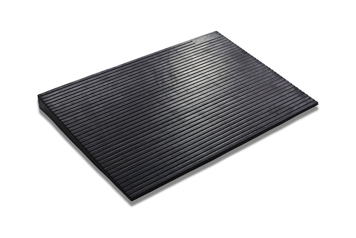 Wheelchair going up rubber ramp 