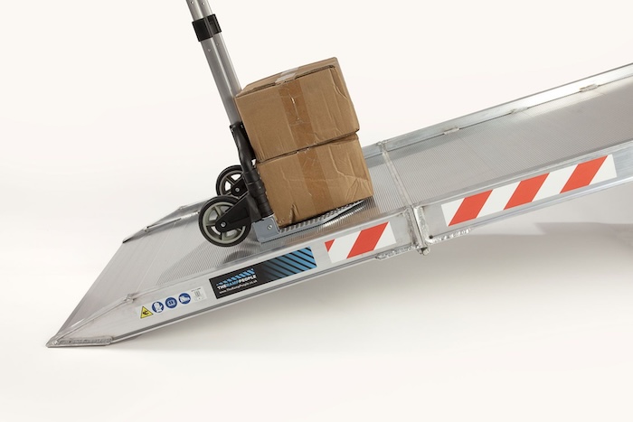 Trolley going up aluminium van ramp