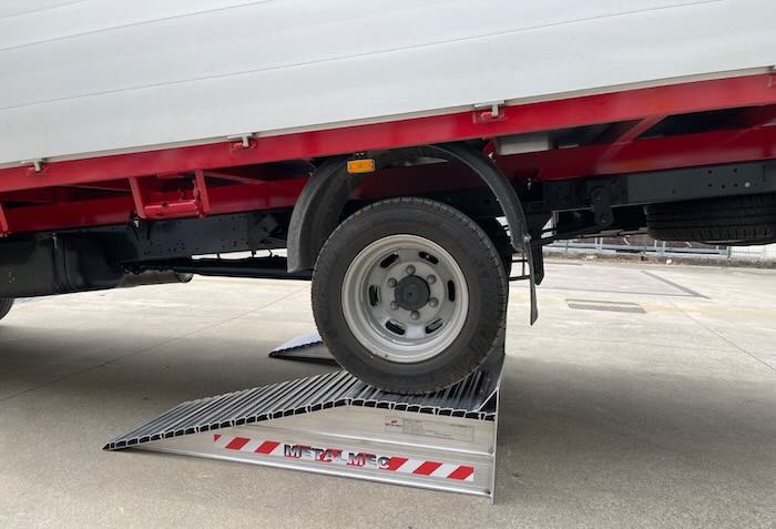 Pair of aluminium wheel risers in loading bay 