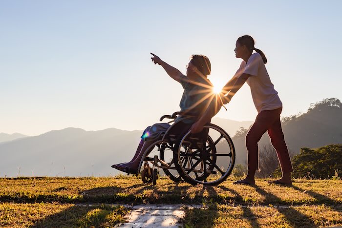 Wheelchair user with a scenic background 