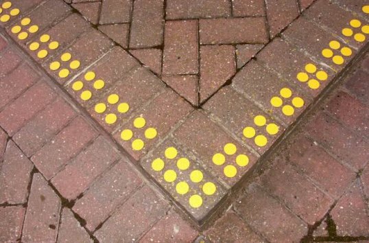 Yellow anti slip discs on corner of step 